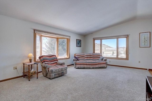 carpeted living room featuring vaulted ceiling and a mountain view