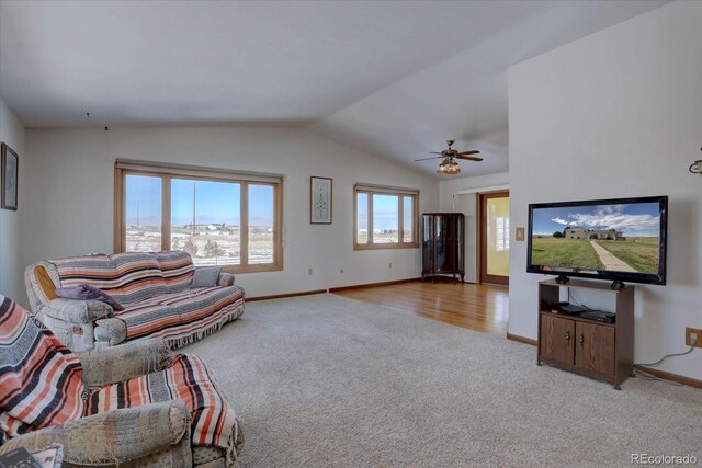 living room featuring light carpet, lofted ceiling, and ceiling fan