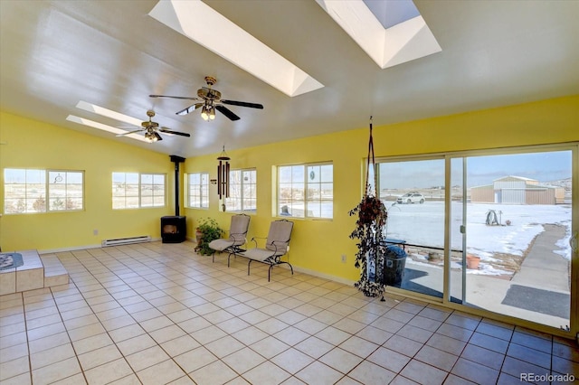 11810 Mesa View Rd, Larkspur, CO 80118 - living area featuring a skylight, baseboard heating, a wood stove, light tile patterned flooring, and vaulted ceiling