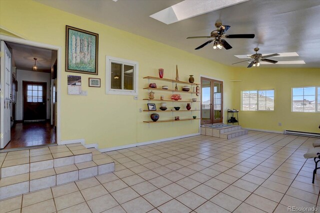 11810 Mesa View Rd, Larkspur, CO 80118 - unfurnished room featuring light tile patterned floors, a baseboard radiator, a skylight, and healthy amount of natural light