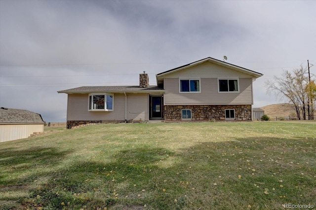 11810 Mesa View Rd, Larkspur, CO 80118 - rear view of house with a chimney, a yard, and stone siding