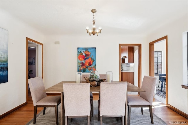 dining room featuring hardwood / wood-style flooring and a notable chandelier