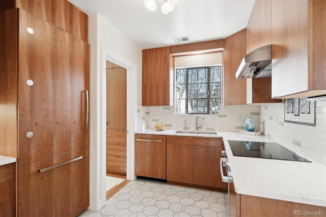 kitchen featuring sink, extractor fan, paneled built in refrigerator, black electric stovetop, and decorative backsplash