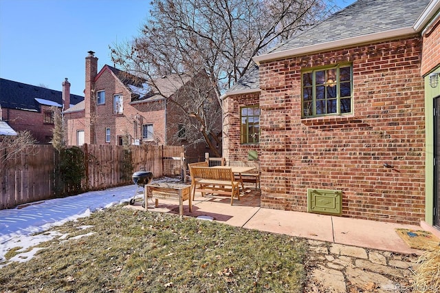 yard covered in snow featuring a patio area