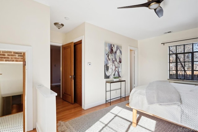 bedroom featuring ceiling fan, light hardwood / wood-style floors, and a closet