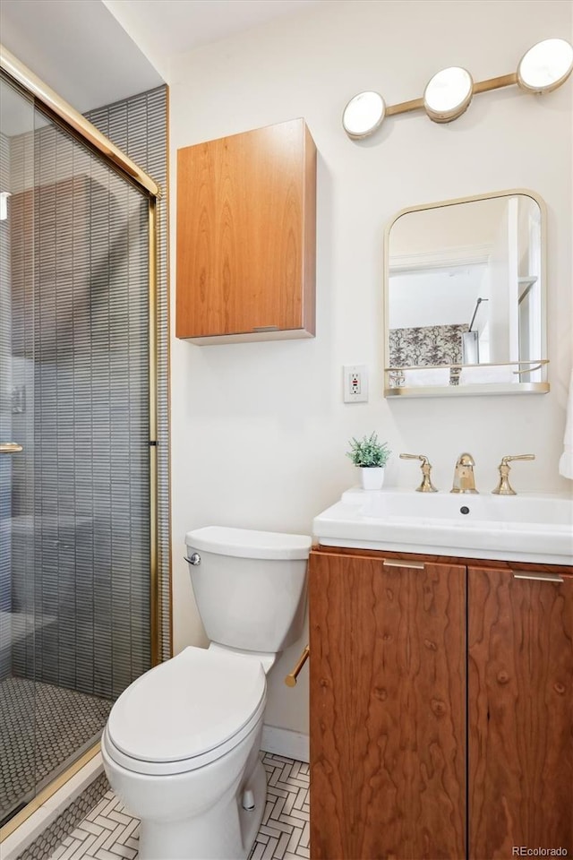 bathroom with vanity, an enclosed shower, and toilet