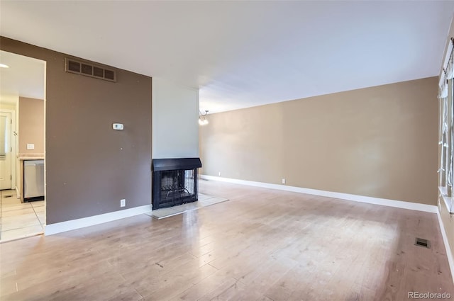 8759 E Roundtree Ave, Greenwood Village, CO 80111 - unfurnished living room featuring light wood-type flooring