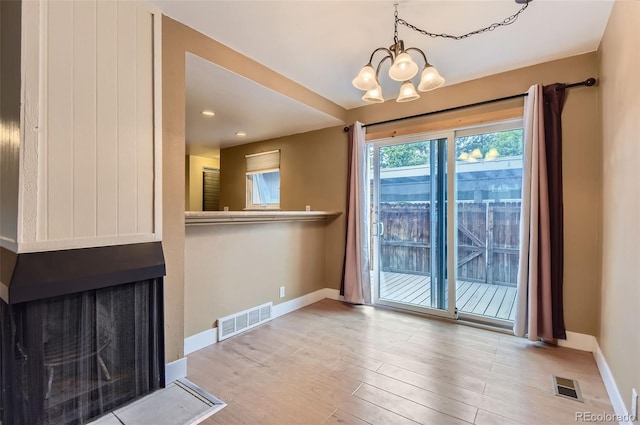 8759 E Roundtree Ave, Greenwood Village, CO 80111 - unfurnished living room featuring a chandelier, wood finished floors, recessed lighting, and a multi sided fireplace
