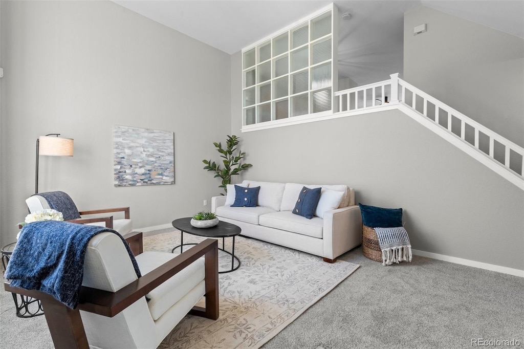 carpeted living room featuring lofted ceiling