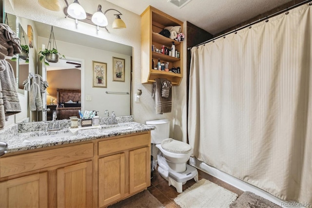 4759 Mt Princeton, Brighton, CO 80601 - ensuite bathroom with double vanity, toilet, curtained shower, and tile patterned flooring