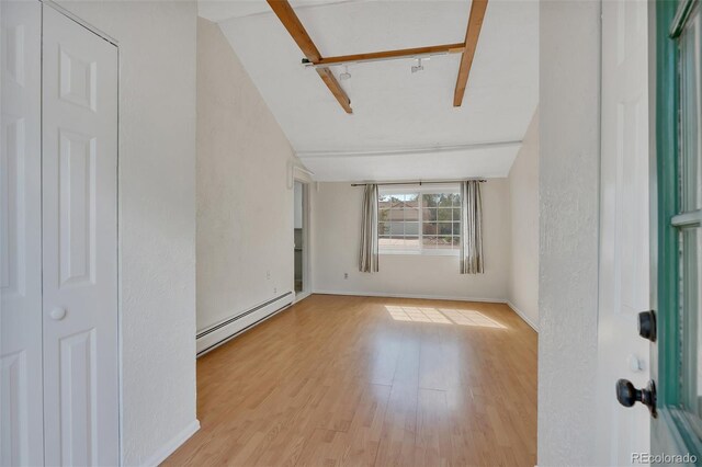 4480 S Pennsylvania St, Englewood, CO 80113 - unfurnished room featuring a baseboard heating unit and wood finished floors