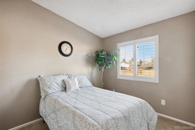 bedroom featuring carpet flooring and a textured ceiling