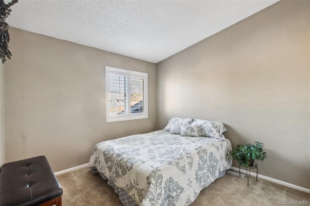 bedroom with a textured ceiling, light colored carpet, and vaulted ceiling