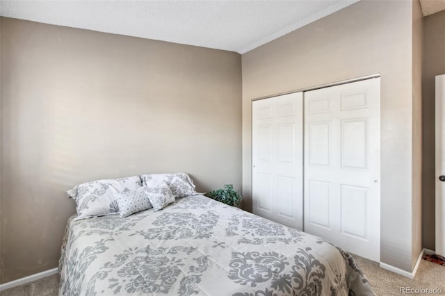 bedroom with a closet, carpet, and a textured ceiling