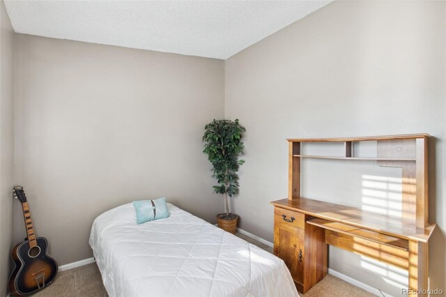 carpeted bedroom with a textured ceiling
