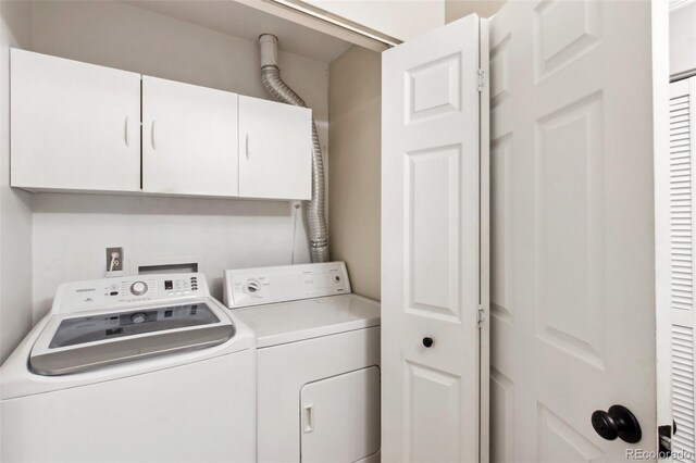 laundry room with washer and clothes dryer and cabinets
