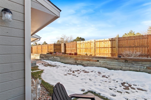 view of yard layered in snow