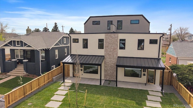 1423 Xavier St, Denver, CO 80204 - back of property featuring a standing seam roof, a patio area, stucco siding, and metal roof