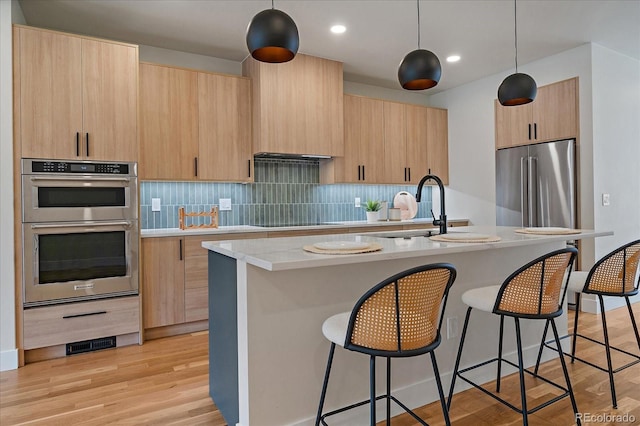 1423 Xavier St, Denver, CO 80204 - kitchen featuring stainless steel appliances, light brown cabinets, a sink, light countertops, and modern cabinets