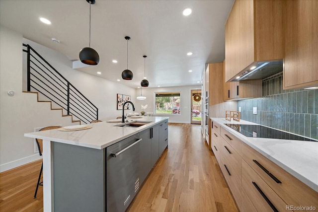 1423 Xavier St, Denver, CO 80204 - kitchen with dishwasher, modern cabinets, a sink, light wood-style floors, and an island with sink