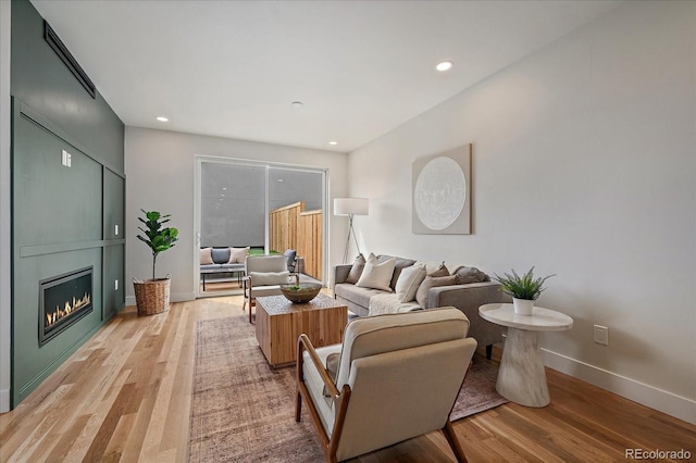 1423 Xavier St, Denver, CO 80204 - living area with light wood finished floors, baseboards, recessed lighting, and a fireplace