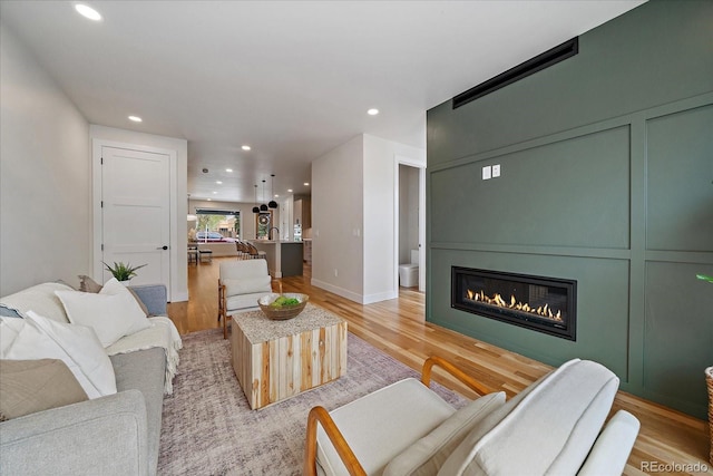 1423 Xavier St, Denver, CO 80204 - living room with recessed lighting, a large fireplace, light wood-style flooring, and baseboards