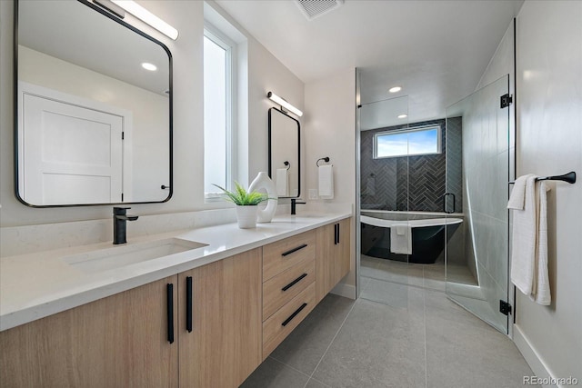 1423 Xavier St, Denver, CO 80204 - full bath with double vanity, a freestanding tub, a stall shower, baseboards, and recessed lighting