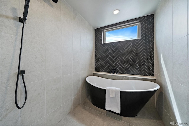 1423 Xavier St, Denver, CO 80204 - bathroom with tile walls, a freestanding bath, and tile patterned flooring