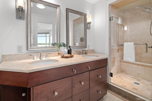 bathroom featuring a sink, double vanity, a shower stall, and tile patterned flooring