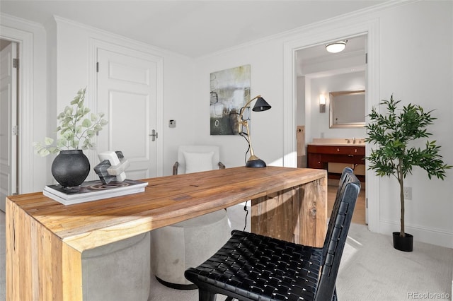 office space with light colored carpet, baseboards, and ornamental molding