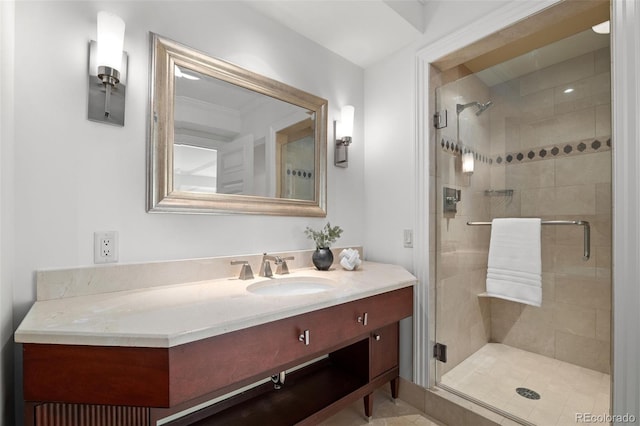 bathroom with a shower stall and vanity