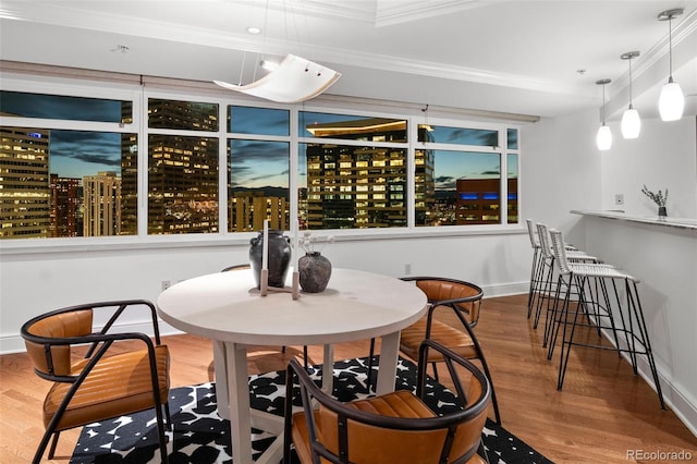 1891 Curtis St Unit 1820, Denver, CO 80202 - dining room with crown molding, wood finished floors, and baseboards