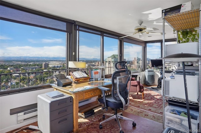 home office with a ceiling fan and a city view