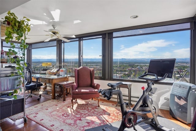 sunroom featuring a ceiling fan