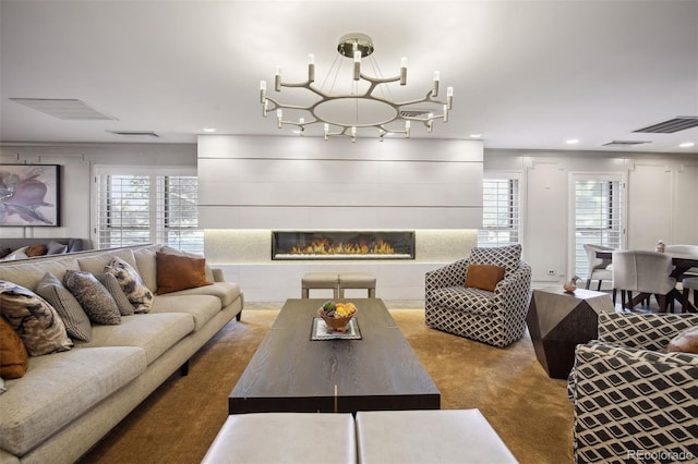 carpeted living area featuring plenty of natural light, visible vents, ornamental molding, and a tile fireplace