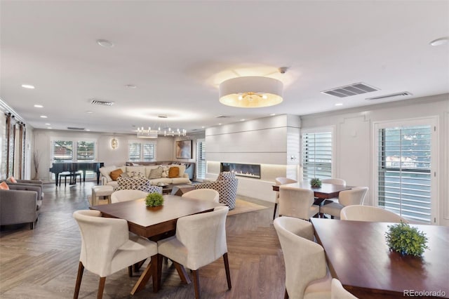 dining room with a healthy amount of sunlight, visible vents, and a fireplace