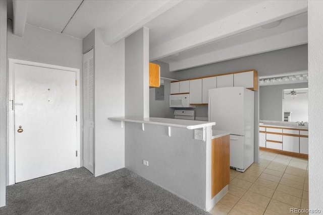 kitchen featuring white appliances, a breakfast bar, a peninsula, white cabinetry, and light tile patterned flooring