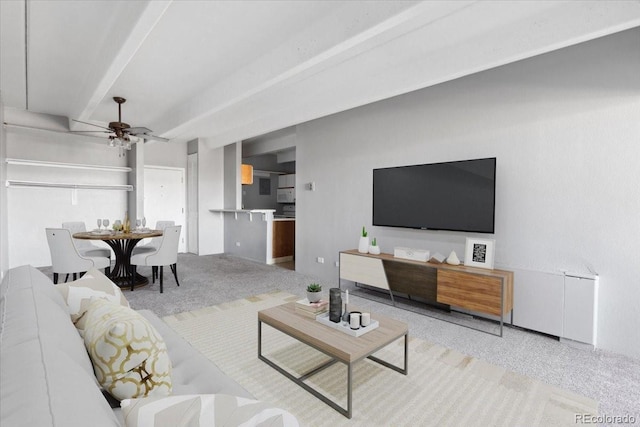 carpeted living area featuring beamed ceiling and a ceiling fan