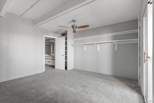 unfurnished bedroom featuring a closet, carpet, and a ceiling fan