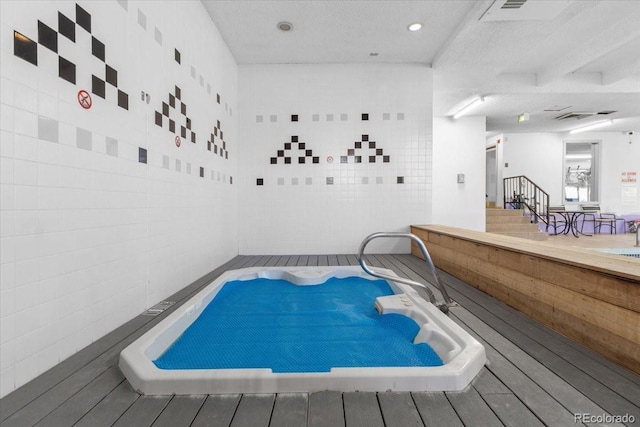 view of pool featuring hot tub deck surround