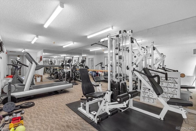 gym featuring a textured ceiling and carpet flooring