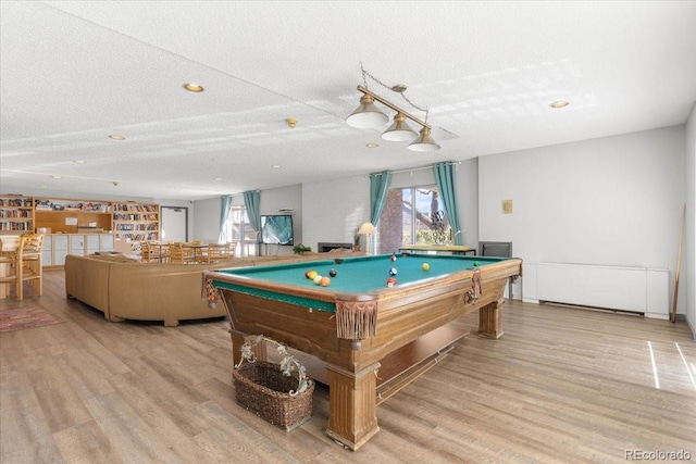 game room with billiards, a textured ceiling, and wood finished floors