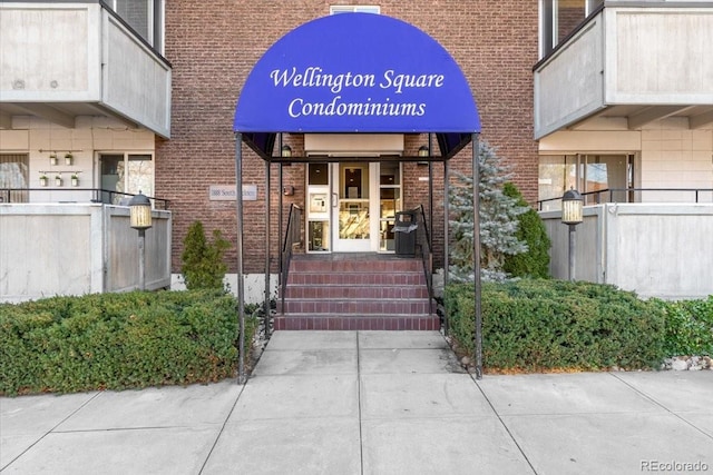 property entrance featuring brick siding