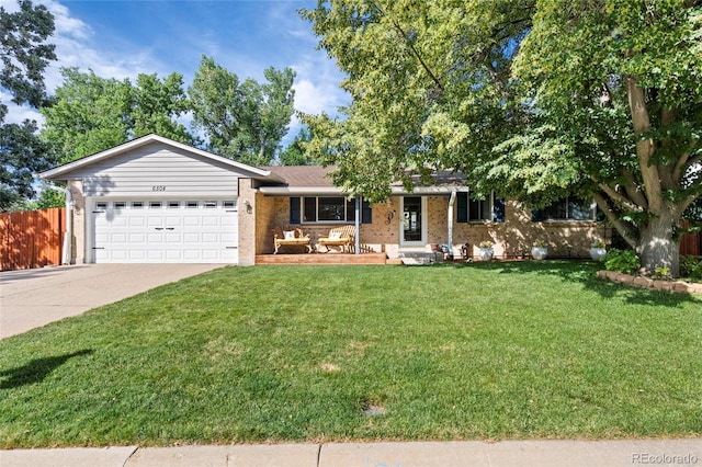6504 W 85th Ave, Arvada, CO 80003 - ranch-style house featuring driveway, brick siding, an attached garage, and a porch
