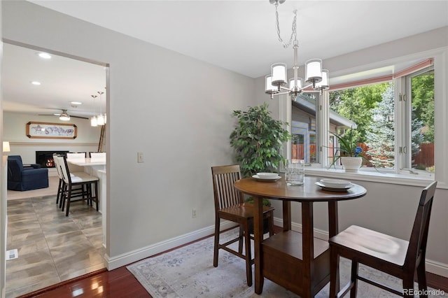 6504 W 85th Ave, Arvada, CO 80003 - dining area featuring a chandelier, a ceiling fan, light wood-style floors, and recessed lighting