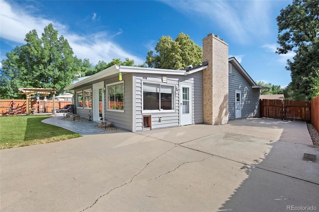 6504 W 85th Ave, Arvada, CO 80003 - back of house featuring a patio area and a chimney