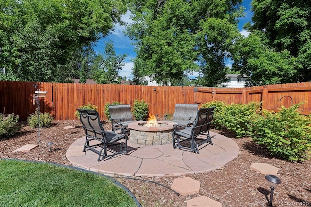 6504 W 85th Ave, Arvada, CO 80003 - fenced backyard featuring an outdoor fire pit and a patio area