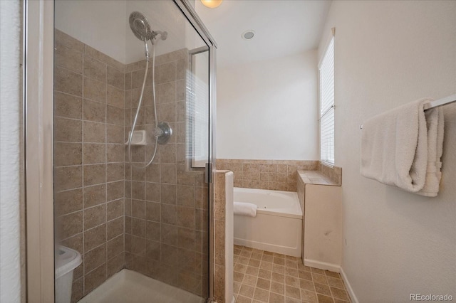 full bathroom with a bath and a stall shower