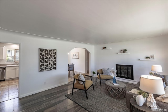 8800 W Kentucky Ave, Lakewood, CO 80226 - living area with arched walkways, dark wood-type flooring, and baseboards