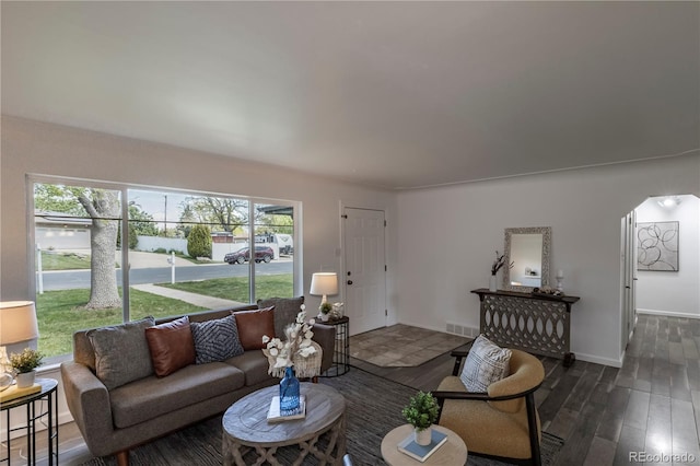 8800 W Kentucky Ave, Lakewood, CO 80226 - living area featuring wood finished floors, arched walkways, and baseboards